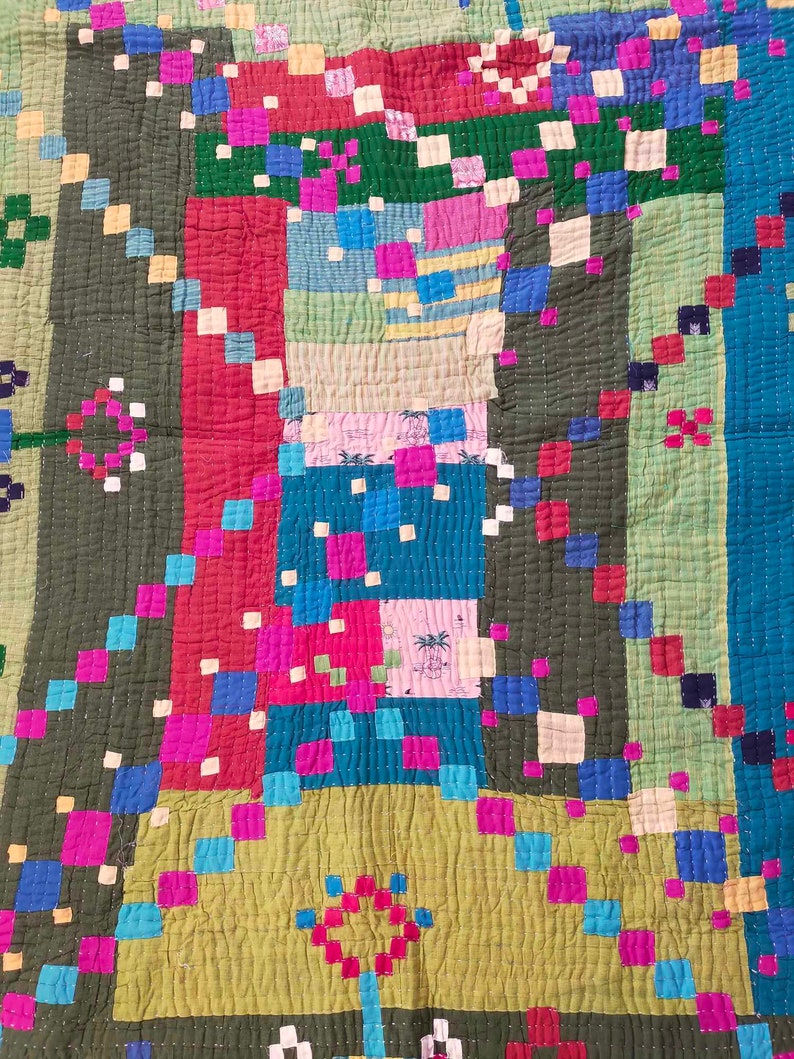 May include: A colorful patchwork quilt with a geometric pattern of squares and rectangles in shades of green, blue, pink, red, and yellow.