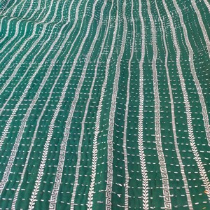 May include: A green kantha quilt with white stitching in a geometric pattern. The quilt is made of cotton and is hand-stitched.