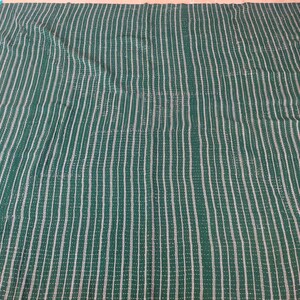 May include: A green and white striped fabric with a woven texture.