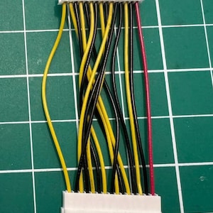May include: A white connector with 15 pins and a bundle of wires. The wires are black, yellow, and red.