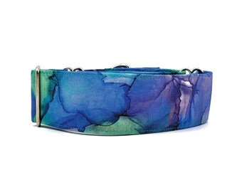 May include: A blue, green, and purple dog collar with a silver buckle. The collar has a watercolor-like design.