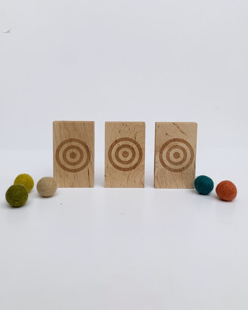 Wool Mob's Wood Slingshot Targets are handmade from sustainably harvested Maple wood and laser engraved with a three ringed target image. Shown is the light Maple wood slingshot targets.