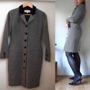 May include: A black and white herringbone patterned dress with a black velvet collar and button closure. The dress has a fitted silhouette and is knee-length.
