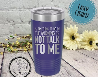 May include: A purple insulated tumbler with a silver lid. The text "A FUN THING TO DO IN THE MORNING IS NOT TALK TO ME" is etched in silver. The tumbler has a ridged design and is laser etched.