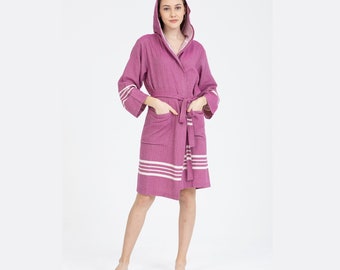 May include: A hooded robe with a pink and white striped pattern. The robe has a tie belt and two pockets.