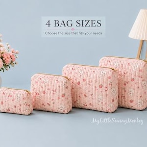 May include: Four quilted pouches in varying sizes, each featuring a light pink fabric with a small floral and animal print, gold-tone zippers, and vertical stitching. The text 4 BAG SIZES Choose the size that fits your needs is visible above.