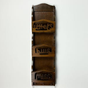 May include: A wooden wall-mounted mail organiser with three compartments labelled "letters", "bills", and "misc".