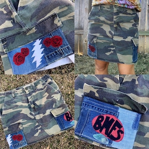 May include: A camouflage cargo skirt with patches of denim and red roses. The denim patches have the words "BLUES" and a lightning bolt graphic.