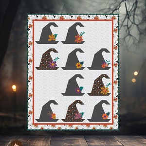 May include: A quilt pattern with a repeating design of witch hats, each decorated with floral details. The finished quilt size is 157 cm x 201 cm. The words "WITCH'S HAT" are at the top.