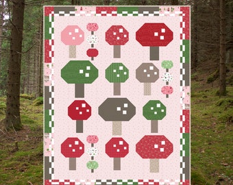 May include: A quilt pattern titled "Mushroom Garden" featuring a repeating pattern of stylized mushrooms in red, green, and gray on a pink background. The quilt measures 62 inches by 78 inches.