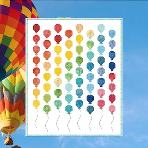 Puede incluir: Un patrón de edredón titulado "Balloon Release" con un diseño de globos coloridos en gradiente contra un cielo azul. El tamaño final del edredón es de 132 cm x 163 cm. Un globo aerostático es visible a la izquierda.
