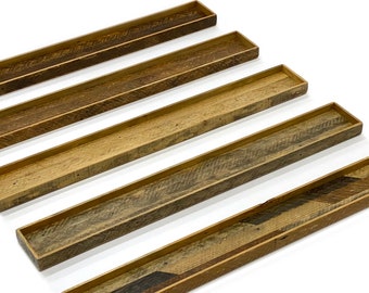 May include: Five wooden trays of varying lengths, each with a different wood grain pattern. The trays are arranged in a staggered formation, with the longest tray at the bottom and the shortest tray at the top.