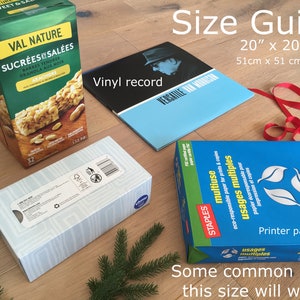May include: A size guide for wrapping gifts, showing common items that can be wrapped in a 20" x 20" square. The items include a box of granola bars, a vinyl record, a box of tissues, and a package of printer paper.