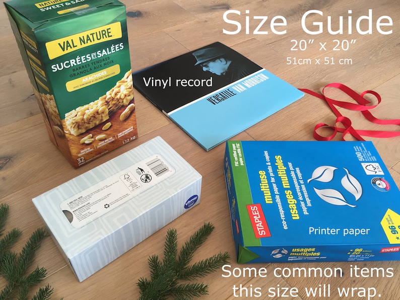 May include: A size guide for wrapping gifts, showing common items that can be wrapped in a 20" x 20" square. The items include a box of granola bars, a vinyl record, a box of tissues, and a package of printer paper.
