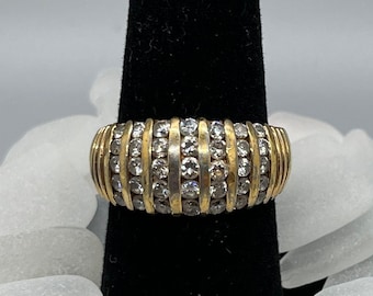 Woman&#39;s gold and CZ ring. 7 stripes with 5 CZ in each stripe.  Size 9