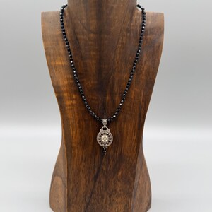 May include: A set of three ceramic mugs with a speckled, matte finish in cream, light grey, and dark grey. Each mug has a simple, minimalist design and a rounded handle.