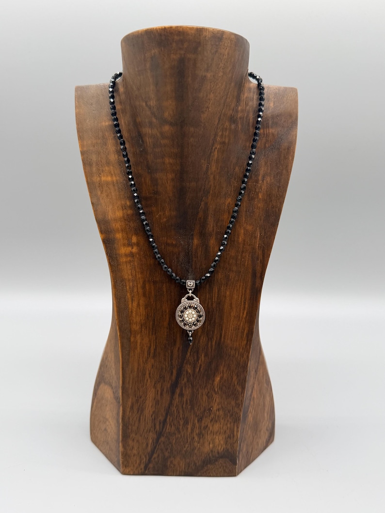 May include: A set of three ceramic mugs with a speckled, matte finish in cream, light grey, and dark grey. Each mug has a simple, minimalist design and a rounded handle.