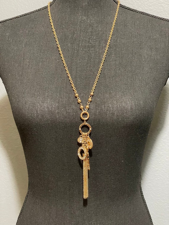 GUESS Gold tone charm necklace with rhinestone acc