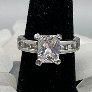 925 Emerald cut crystal ring w baguettes on sides.  Size 8.25