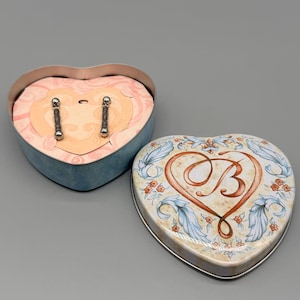 May include: A set of three ceramic mugs with a speckled, matte finish. The mugs are in shades of cream, light gray, and dark gray. Each mug has a simple, minimalist design, perfect for coffee or tea.