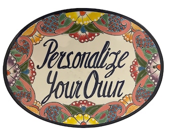 May include: A white oval ceramic plate with a colorful floral border and the text "Personalize Your Own" in blue lettering.
