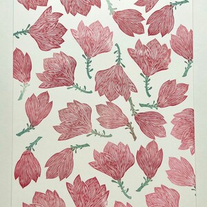 May include: A white background with a repeating pattern of pink magnolia flowers with green stems. The flowers are stylized and have a line drawing aesthetic.