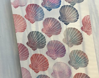 May include: A notebook with a pattern of colorful seashells printed on the pages. The shells are in shades of pink, purple, blue, and green.