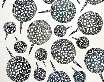 May include: A white background with a pattern of black and white stingray silhouettes. The stingrays are all different sizes and have a speckled pattern.