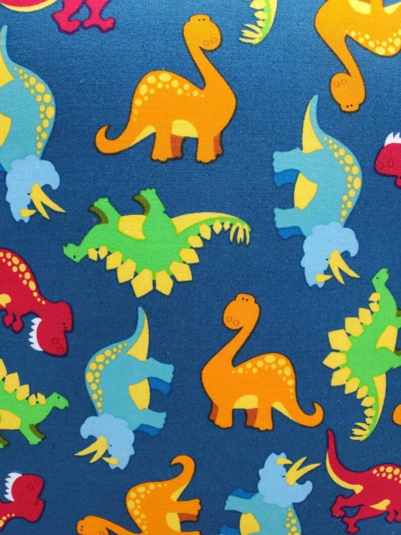 May include: Blue fabric with a repeating pattern of colorful dinosaurs. The dinosaurs are in various poses, including standing, walking, and running. The fabric is perfect for crafting projects, such as making quilts, pillows, and tote bags.