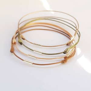 bracelet cordon fin avec perle tube  en argent unisexe