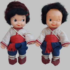 a couple of dolls sitting next to each other
