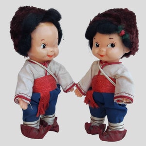 a couple of dolls standing next to each other