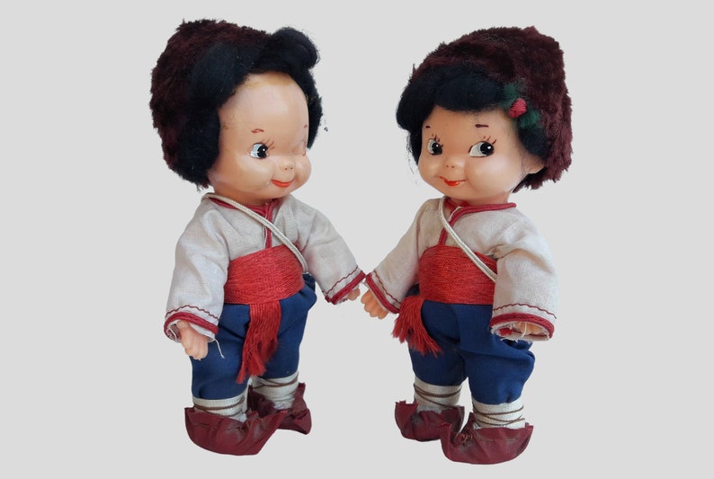 a couple of dolls standing next to each other