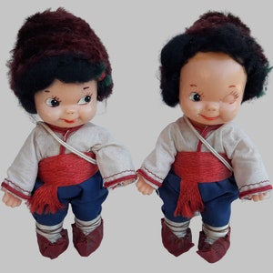 a couple of dolls sitting next to each other