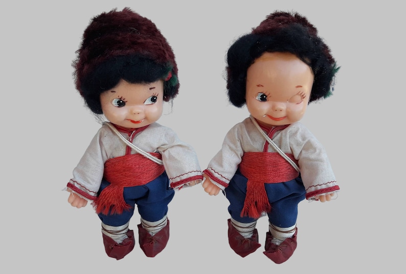 a couple of dolls sitting next to each other