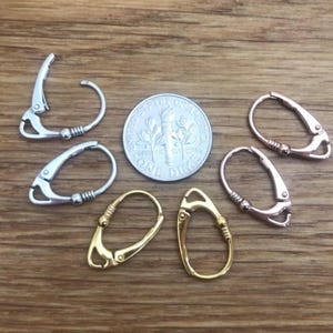 Multiple leverback earrings in silver, gold, and rose gold finishes with.