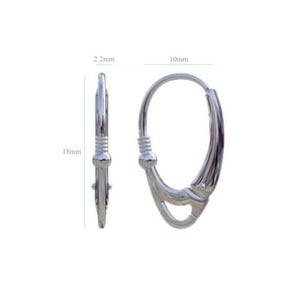 Sterling silver leverback earrings shown in an open position on a wooden surface.