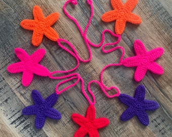 Crocheted fun and bright star bunting.  Handmade orange, pink, purple and red starfish garland.