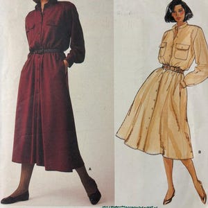 May include: A Vogue Patterns American Designer sewing pattern envelope for a Calvin Klein shirt dress, pattern 1442. The cover displays a maroon dress labeled A and a beige illustrated dress labeled B, both featuring long sleeves, button fronts, and belts.