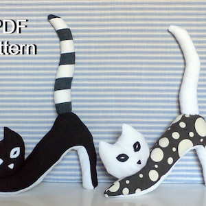 May include: PDF pattern for two black and white cat toys. One cat has a striped tail and the other has a polka dot tail. Both cats are wearing high heels.