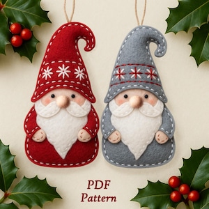 Pode incluir: Dois enfeites de gnomo de feltro, um vermelho e outro cinza, com barbas brancas e chapéus decorados com flocos de neve. Cada enfeite tem uma corda para pendurar. O texto "PDF Pattern" está na parte inferior.