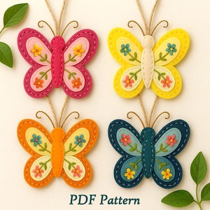 May include: Four colourful felt butterfly ornaments with floral details and string hangers. The butterflies are in shades of pink, yellow, orange, and blue. The text "PDF Pattern" is at the bottom of the image.