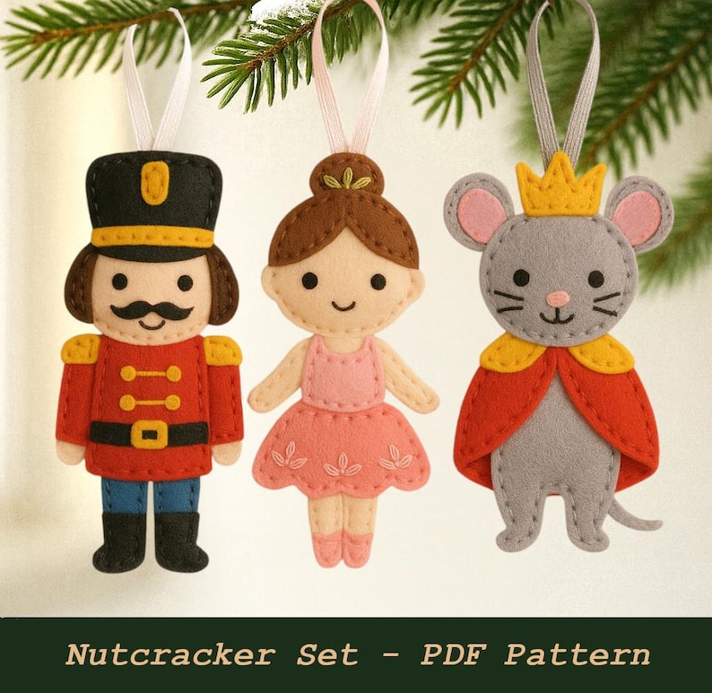 May include: Three felt Christmas ornaments: a nutcracker soldier in red and black, a ballerina in pink, and a gray mouse king with a yellow crown and red cape. The ornaments are hanging from white ribbons.