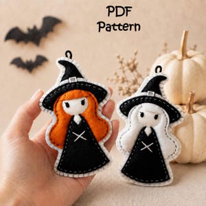 May include: Two felt witch ornaments featuring black pointed hats and dresses with white stitching. One witch has orange hair, the other has white hair. The text PDF Pattern is visible above. Each ornament has a small black loop at the top for hanging.