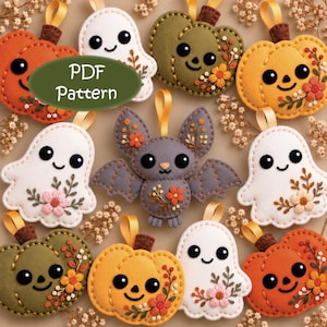May include: A collection of felt ornaments featuring ghosts, pumpkins, and a bat, each with embroidered floral details and a hanging loop. The ornaments are arranged in a group, and a green oval overlay displays the text PDF Pattern.