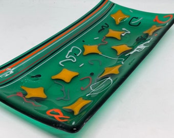 Cosmic Fusion; Modern Fused art glass spoon rest made with green base, orange stars and multicolored accent glass