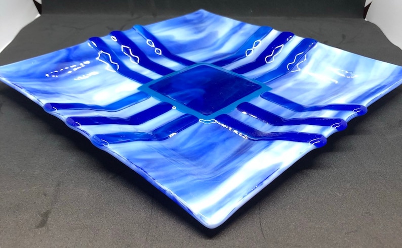 Southwestern style fused art glass plate made with blue and white streaky glass with indigo and cobalt blue accent pieces
