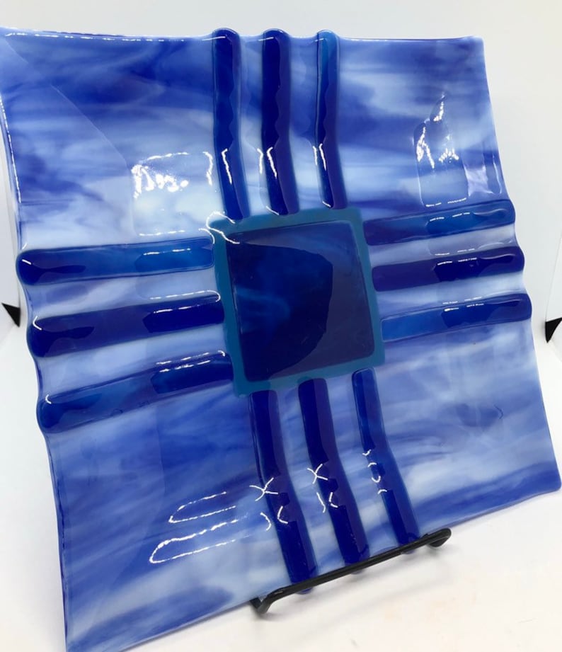 Southwestern style fused art glass plate made with blue and white streaky glass with indigo and cobalt blue accent pieces