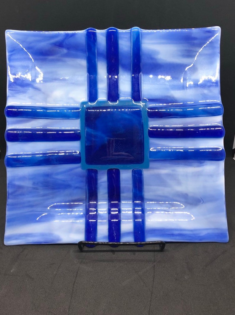 Southwestern style fused art glass plate made with blue and white streaky glass with indigo and cobalt blue accent pieces
