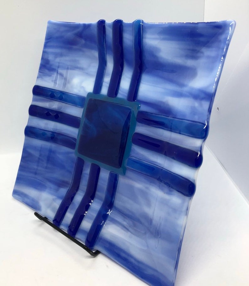 Southwestern style fused art glass plate made with blue and white streaky glass with indigo and cobalt blue accent pieces
